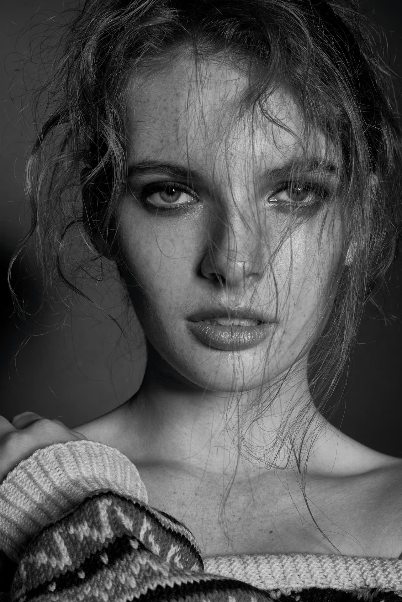 Close black and white portrait with freckles and loose hair