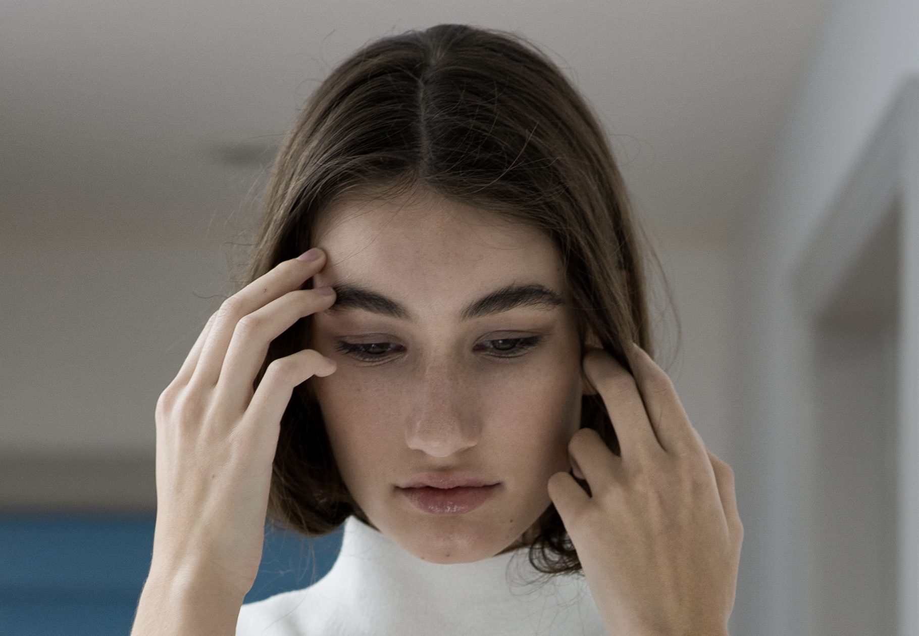 Colour portrait with hands framing the face, natural skin